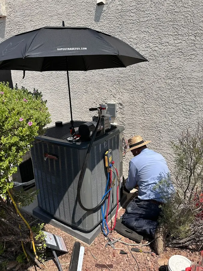 HVAC technician performing outdoor AC maintenance in Tremonton
